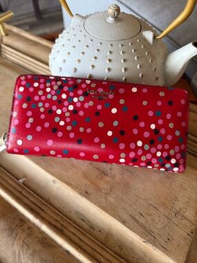 kate spade pink zip-around wallet with gold logo zipper pull